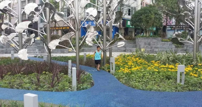 Visitors posing among the ginkgo sculptures