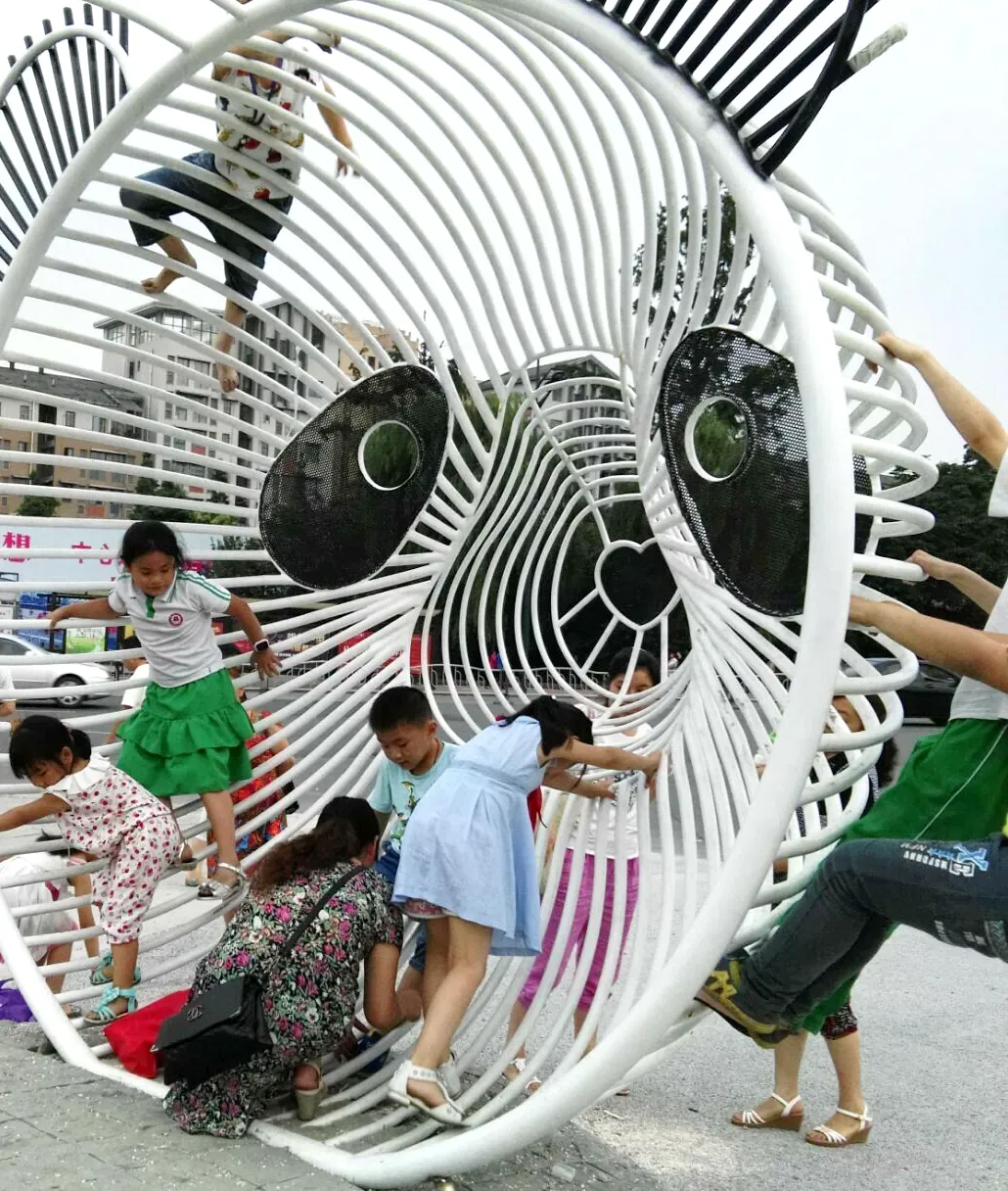 Children climbing inside the Panda Gate sculpture