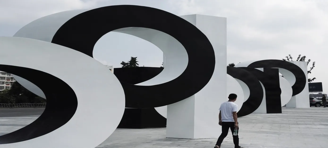 Close view of the black and white letterforms with a person walking past