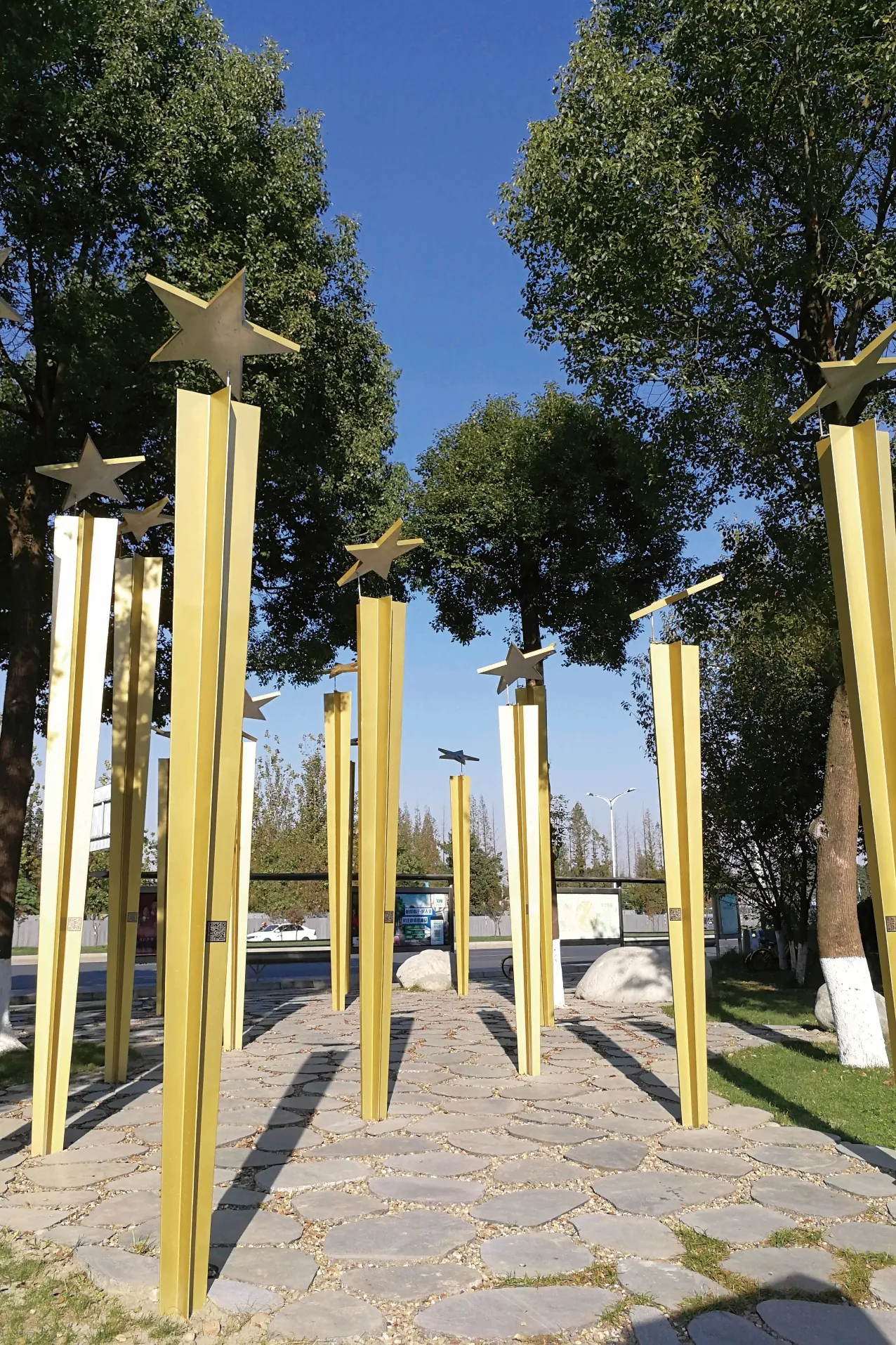 Golden poles topped with stars against a blue sky