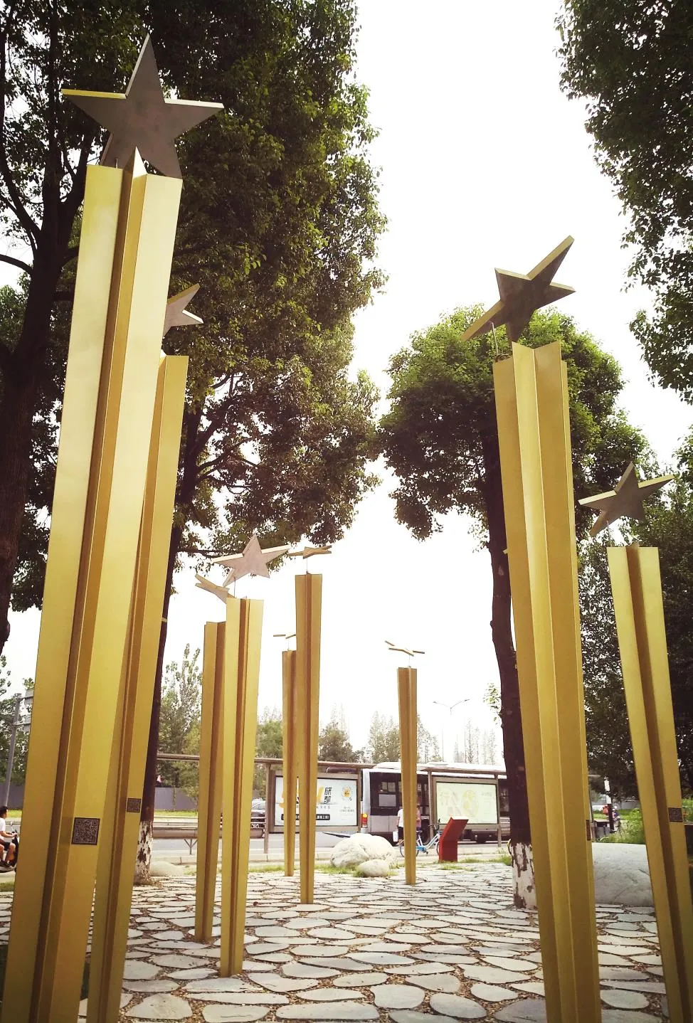 Looking up the golden poles among the trees