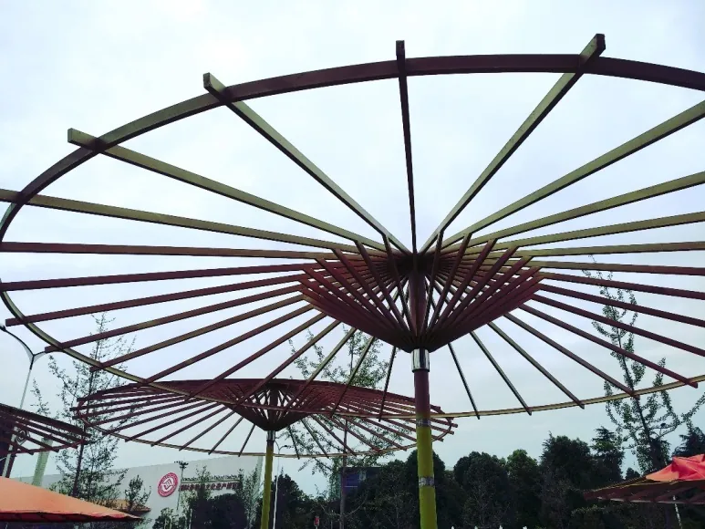 Looking up into the ribs of an umbrella canopy against the sky